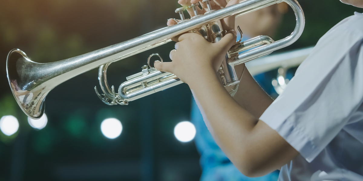 Child playing instrument close up